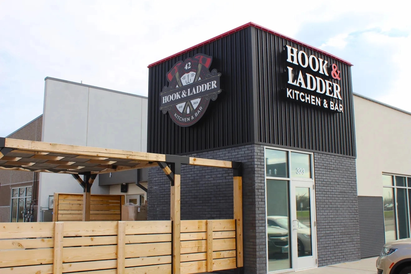 Custom pergola and horizontal wood fence panel exterior commercial construction by Qualified Carpentry at Hook and Ladder Kitchen and Bar Sioux Falls South Dakota