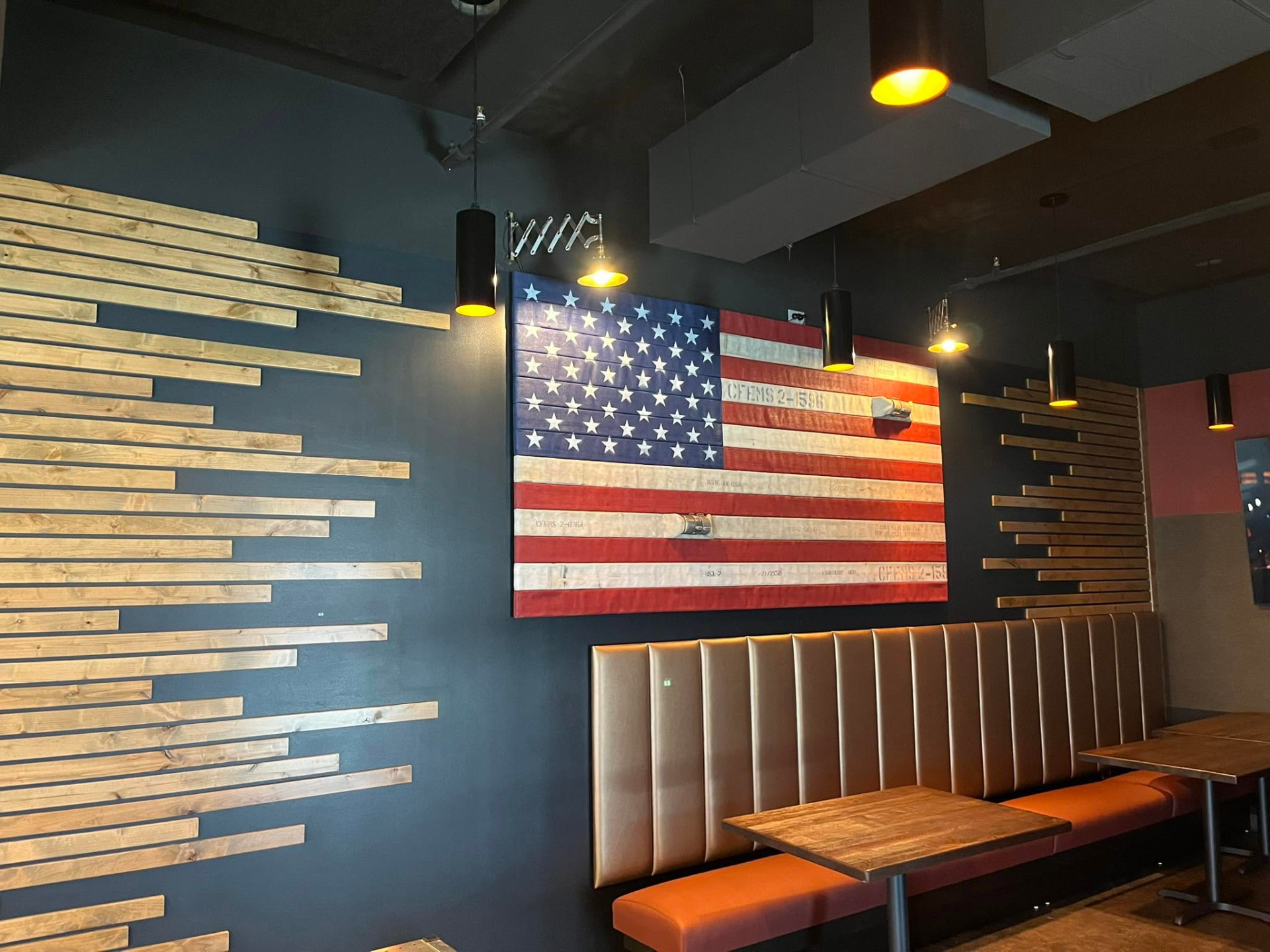 Custom wood slat accent wall and commercial interior finish carpentry by Qualified Carpentry at Hook and Ladder Kitchen and Bar Sioux Falls South Dakota