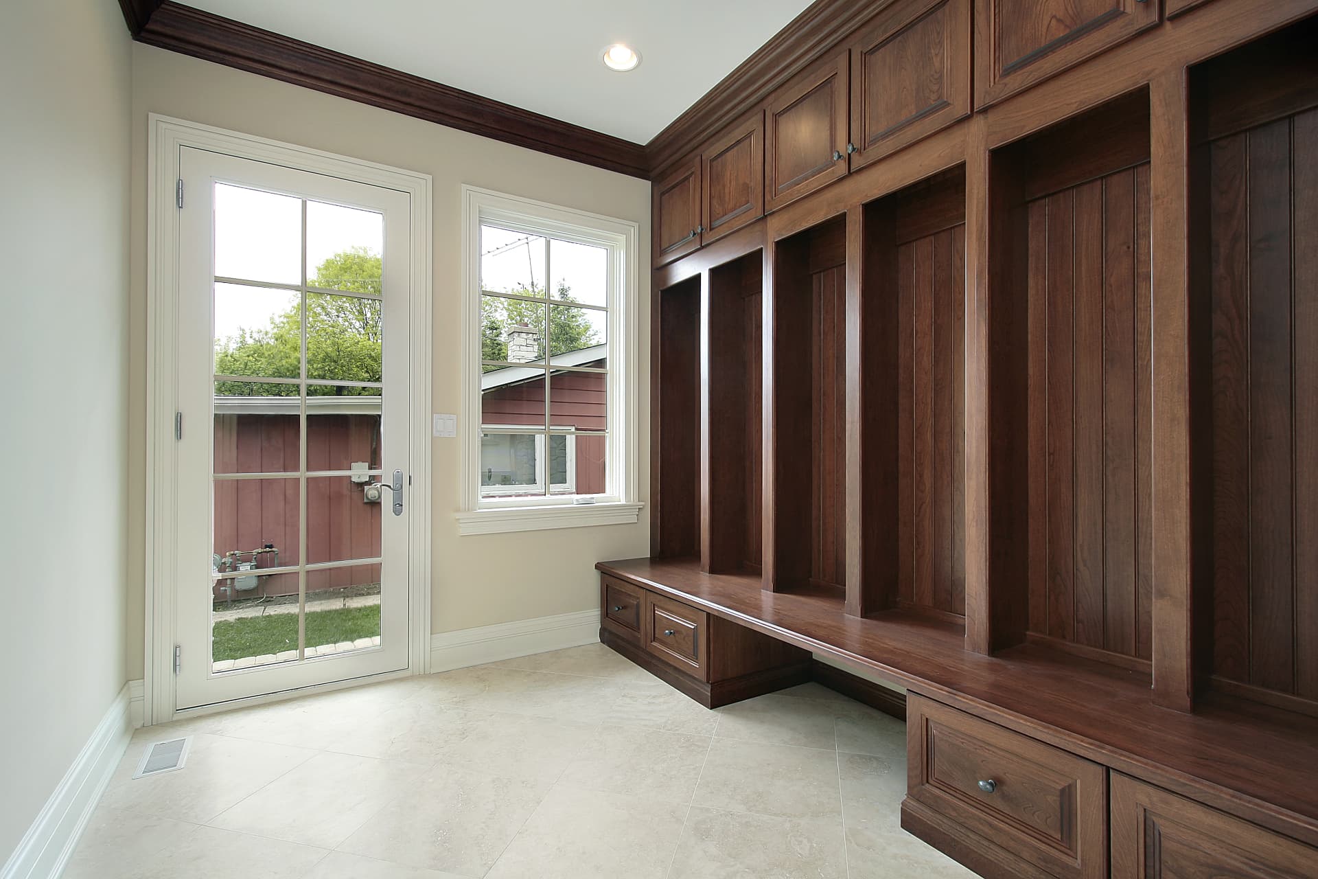 Custom walnut mudroom with built-in cabinetry, bench, and storage system, Sioux Falls SD